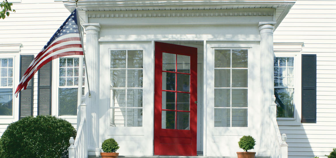 House with red door and American flag